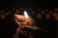 Men hand holding a candle in The dark light with bokeh. Birthday concept Royalty Free Stock Photo