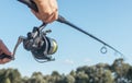 Men hands holding fishing rod or angler over blue clear sky Royalty Free Stock Photo