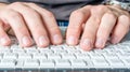 Men hands are typing on computer keyboard