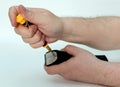 Men hands untwist the bolts with a screwdriver blade clipper the hair