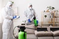 Men in hazmat suits cleaning home, epidemic Royalty Free Stock Photo