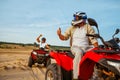 Men in helmets on atv, freedom riding in desert Royalty Free Stock Photo