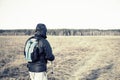 Men hiker portrait in the field with backpack and poles