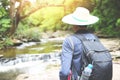 Men hikers mountain nature walking with backpacks and waterfall in the forest adventure travel tourism sports activity