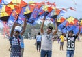 Men hold a Japanese kite on Negombo beach in Sri Lanka. Royalty Free Stock Photo