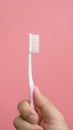 Men holding new toothbrush on a pink background Royalty Free Stock Photo