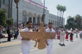 Men holding a sculpture of Faravahar, Iranian symbol