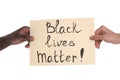 Men holding sign with phrase Black Lives Matter on white background, closeup. Racism concept