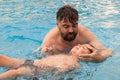 a man holds a disabled child during aquatic therapy in a swimming pool. Royalty Free Stock Photo