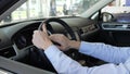 Men holds steering wheel inside car, man`s hands at helm, fortunate