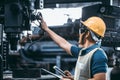 Men industrial engineer wearing a Yellow helmet while standing in a heavy industrial