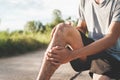 .Men injured from exercise Use your hands to hold your knees at the park Royalty Free Stock Photo