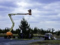 Men installing Christmas tree with hydraulic lift