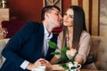 A man kisses a woman in a restaurant over dinner Royalty Free Stock Photo