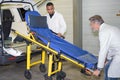 Men loading stretcher into ambulance Royalty Free Stock Photo