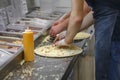 Men make different pizzas in the fast food restaurant Royalty Free Stock Photo