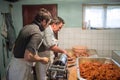 Men making sausages the traditional way using sausage filler. Royalty Free Stock Photo