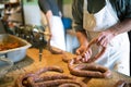 Men making sausages the traditional way using sausage filler. Royalty Free Stock Photo