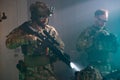 Men in military equipment in dark room Royalty Free Stock Photo