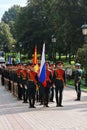 Men in military uniform stand holding flags. Royalty Free Stock Photo