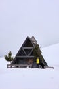 A MEN MODEL IN A Typical wooden chalet in the Dolomites mountain in winter