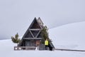 A MEN MODEL IN A Typical wooden chalet in the Dolomites mountain in winter