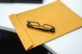 Men modern eyeglasses on brown confidential envelope Royalty Free Stock Photo