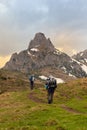 Men Mountain Climbing On Snowy Peak in Ciucas Mountains, Romania Royalty Free Stock Photo