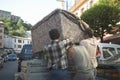 Men moving couch in Ainsa, Huesca, Spain in Pyrenees Mountains Royalty Free Stock Photo