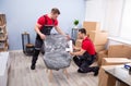 Men Packing The Chair With Plastic Royalty Free Stock Photo