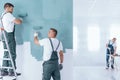 Men painting empty home interior Royalty Free Stock Photo