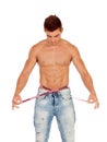 Men with perfect abs measuring his waist Royalty Free Stock Photo