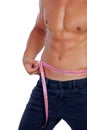 Men with perfect abs measuring his waist Royalty Free Stock Photo