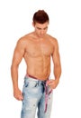 Men with perfect abs measuring his waist Royalty Free Stock Photo