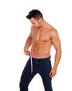 Men with perfect abs measuring his waist Royalty Free Stock Photo