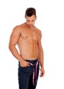 Men with perfect abs measuring his waist Royalty Free Stock Photo