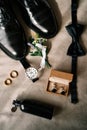 Men perfume, cufflinks, watch and boutonniere lie on the bed next to the groom shoes