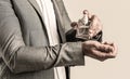 Men perfume in the hand on suit background. Man in formal suit, bottle of perfume, closeup. Fragrance smell. Men