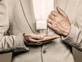 Men perfume in the hand on suit background. Man in formal suit, bottle of perfume, closeup. Fragrance smell. Men