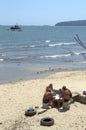 Men play cards on beach