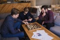Men play chess in a stylish loft cafe with a modern design