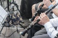 Men play the clarinet in the orchestra. People play on wind instruments Royalty Free Stock Photo