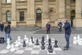 Men play giant outdoor chess game