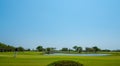 Men playing golf in the middle of the golf course ,Landscape golf course and blud sky Royalty Free Stock Photo