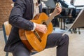 Men playing guitar Handsome young men sitting on chair and playing acoustic guitar Royalty Free Stock Photo