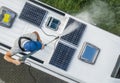 Men Power Washing His Camper Van RV Roof and Solar Panels Royalty Free Stock Photo