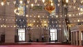 Men pray in mosque decorated with lanterns in Istanbul