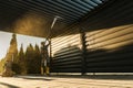 Men with Pressure Washer Cleaning His Residential Aluminium Carport Pergola Royalty Free Stock Photo