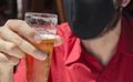 Men with protective face mask holding a glass of beer Royalty Free Stock Photo