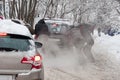 Men push a car that got stuck in a snow at Holosiivskyi National Nature Park, Kyiv, Ukraine Royalty Free Stock Photo